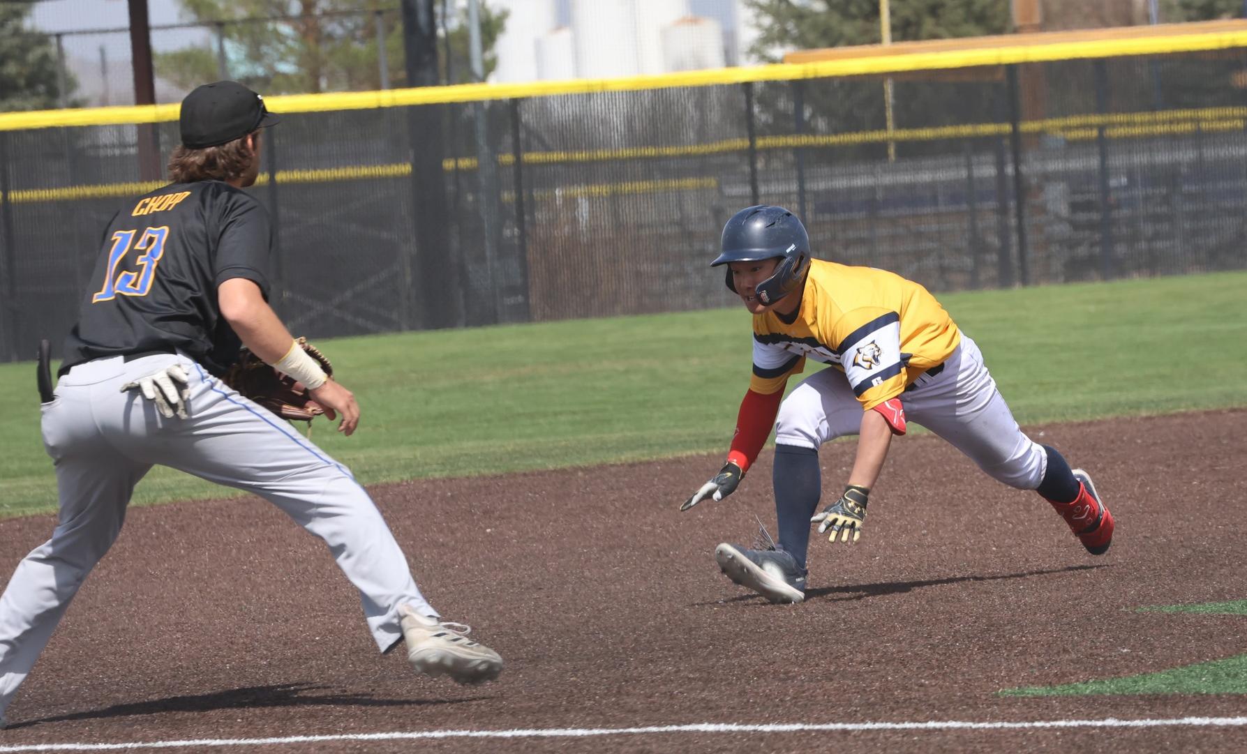 Jin Kobayakawa prepares to slide into third base on his first-inning triple in game two on Saturday against Trinidad.
