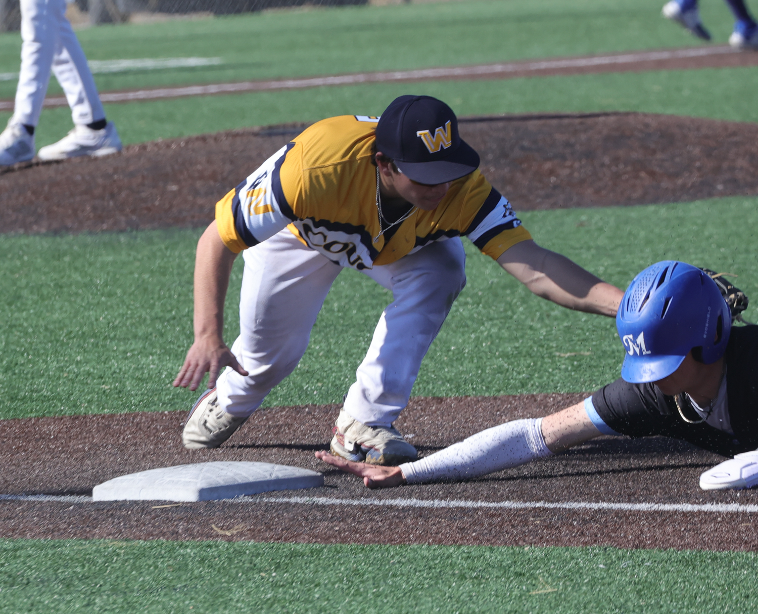 Will Harbison puts a tag on a McCook runner at first base on a pick-off play.