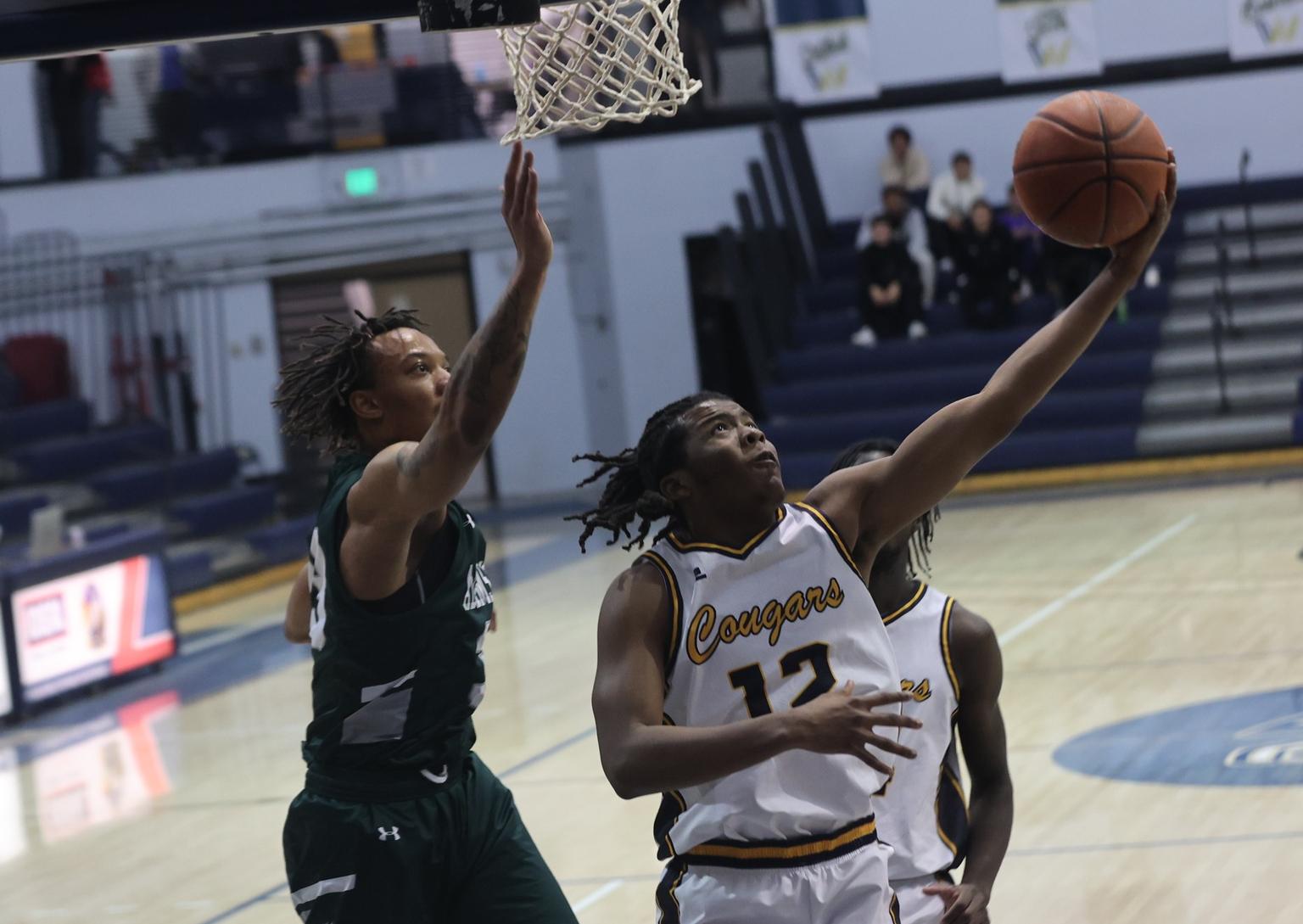 Willie Wilson goes up for two points against Adams State J.V. on Friday.