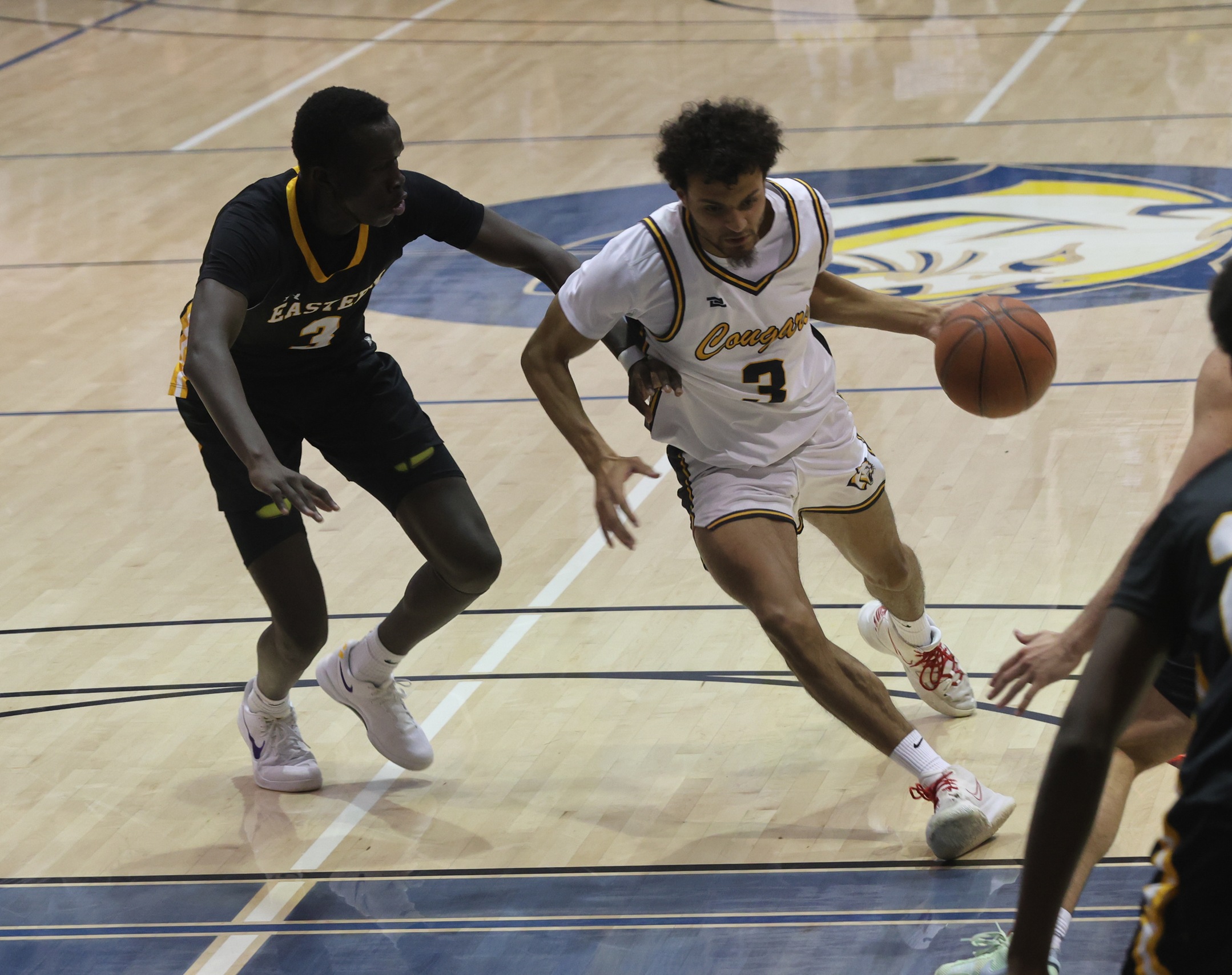Kellon Harris drives to the bucket against an EWC player.