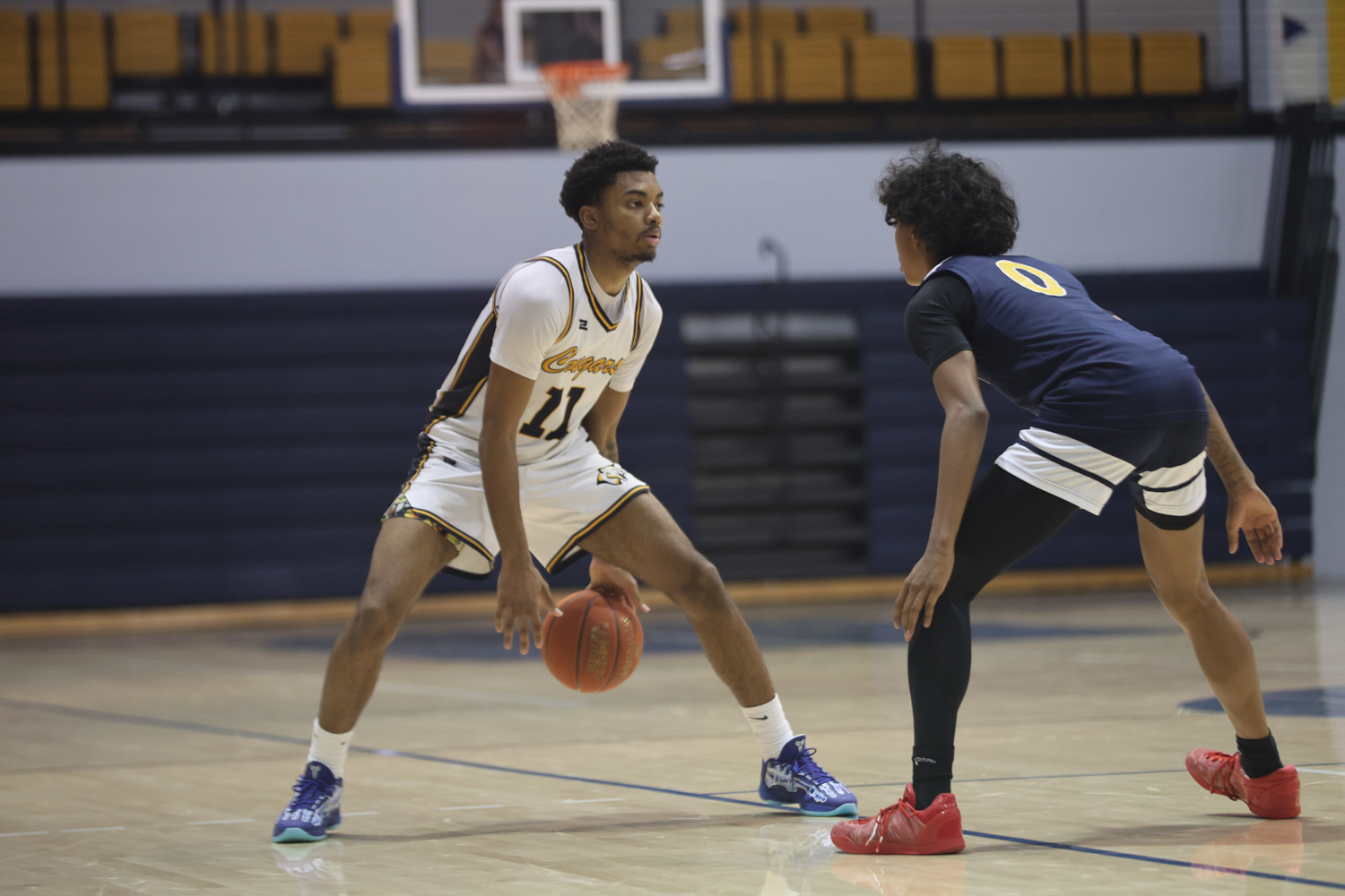 Elijah Hollins dribbles between his legs during the second half of their game with LCCC on Wednesday.