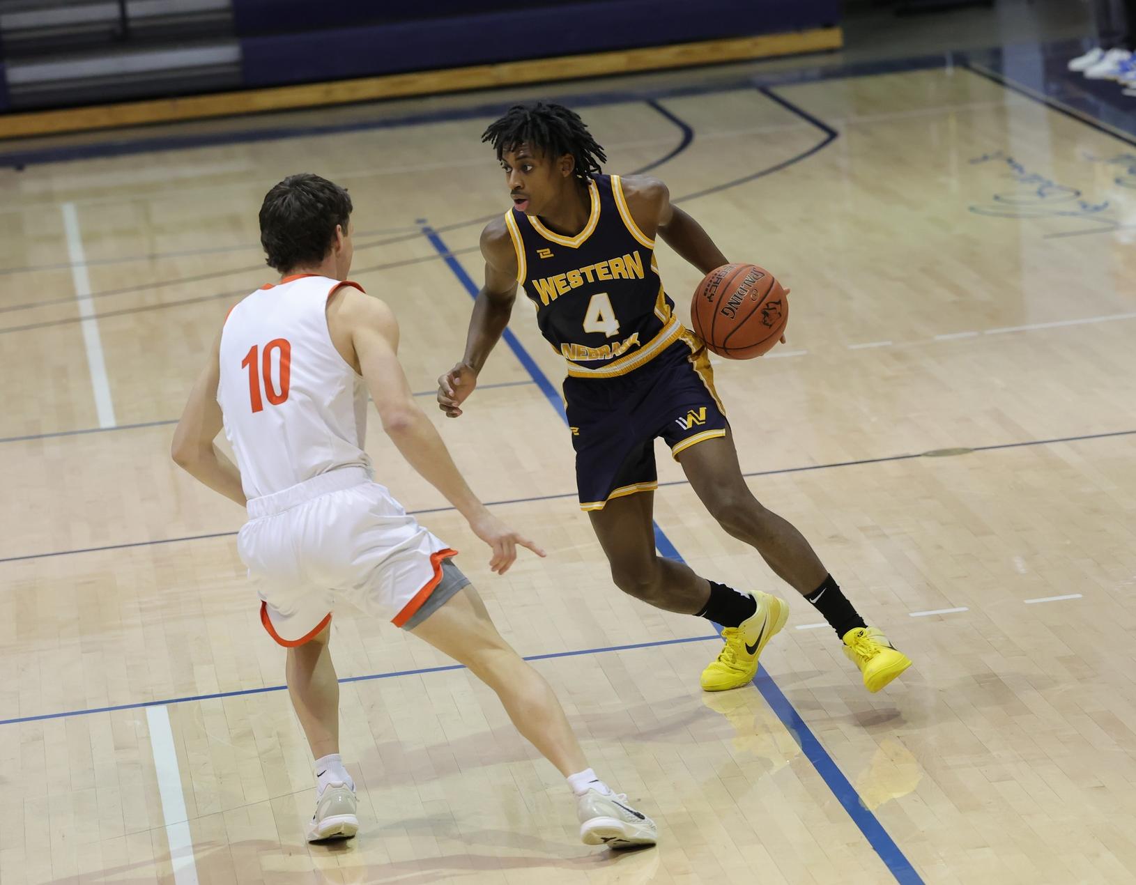 Isaiah St. Preux brings the ball up the court against a Snow College defender during the Cougars with Snow back on October 31 at Cougar Palace.