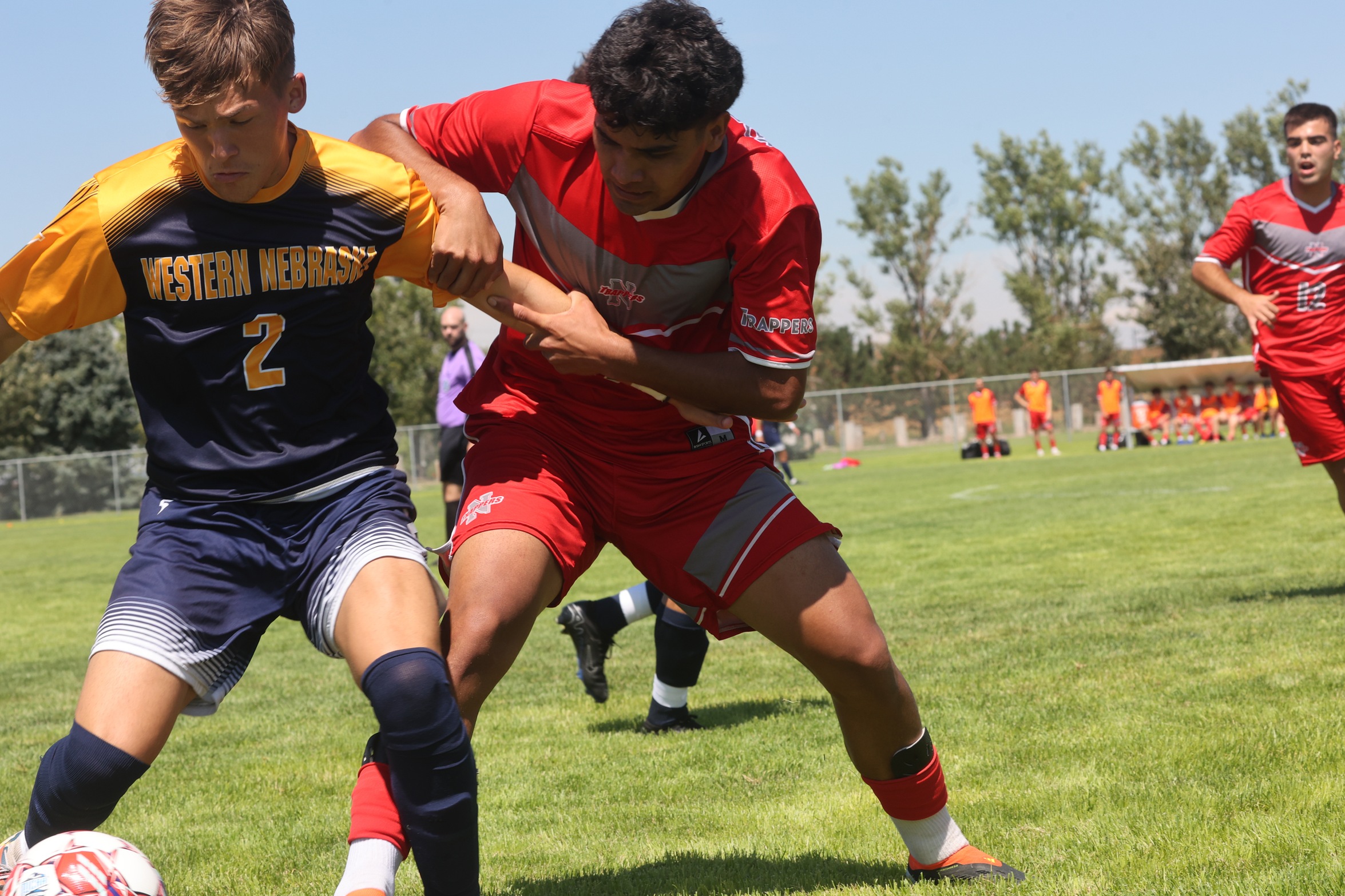 WNCC's Yediel Hernandez gets held by a Northwest player as he goes for the ball.