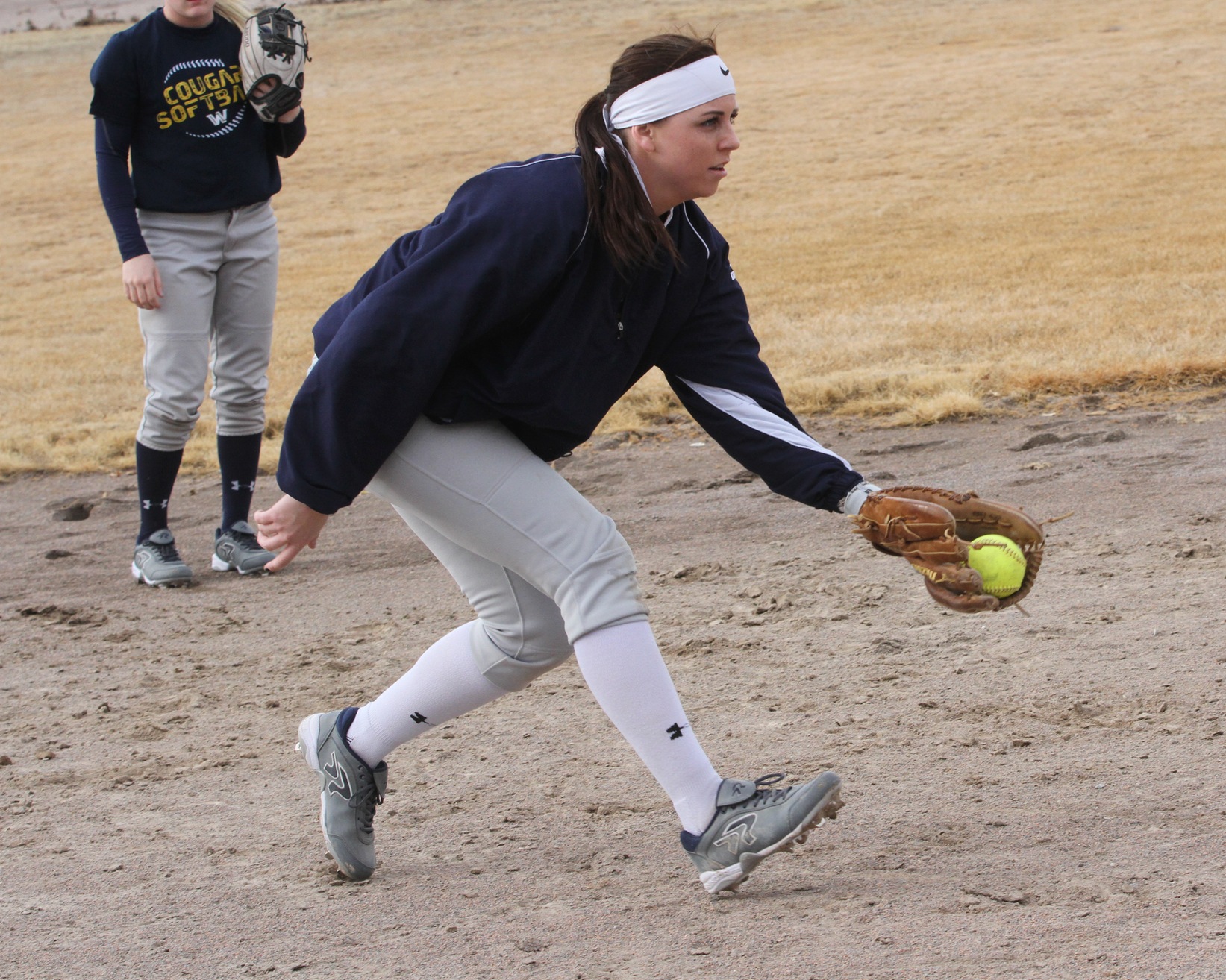 Madi Jackson works on a fielding drill on Monday.