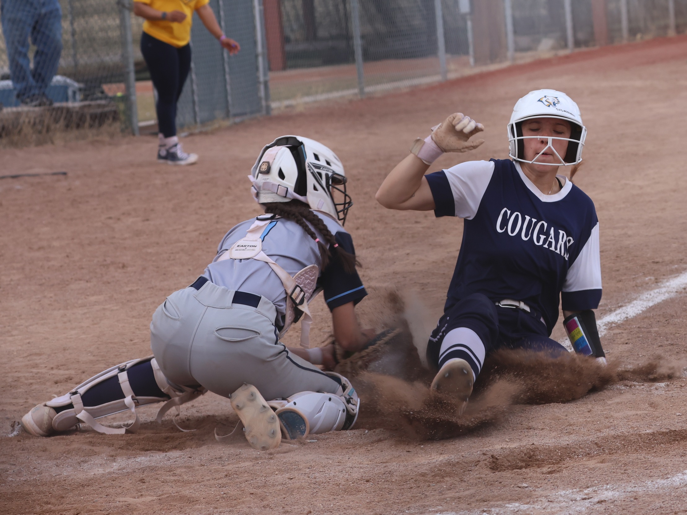 Alyssa Albaugh slides into home plate for a seventh-inning run in the first game against Otero on Thursday.