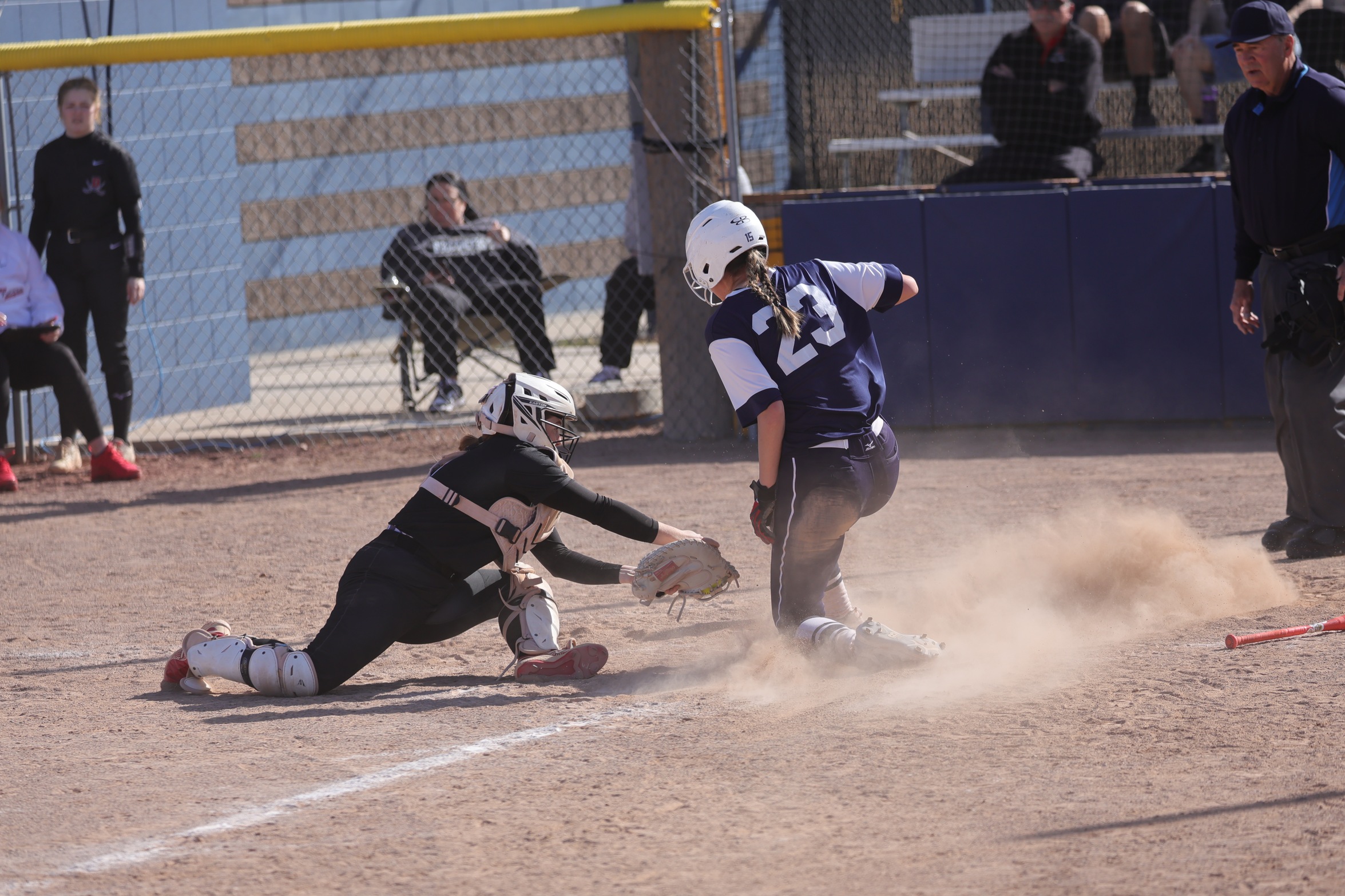 Abbey Arntsen slides home safely in the first game against Dawson on Saturday.