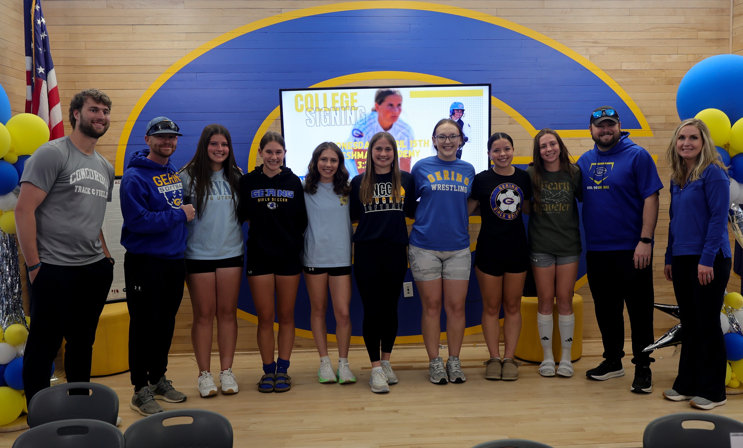Jacelyn Brown stands with some of her softball teammates and coaches during the spring signing ceremony for six Bulldogs on Wednesday.