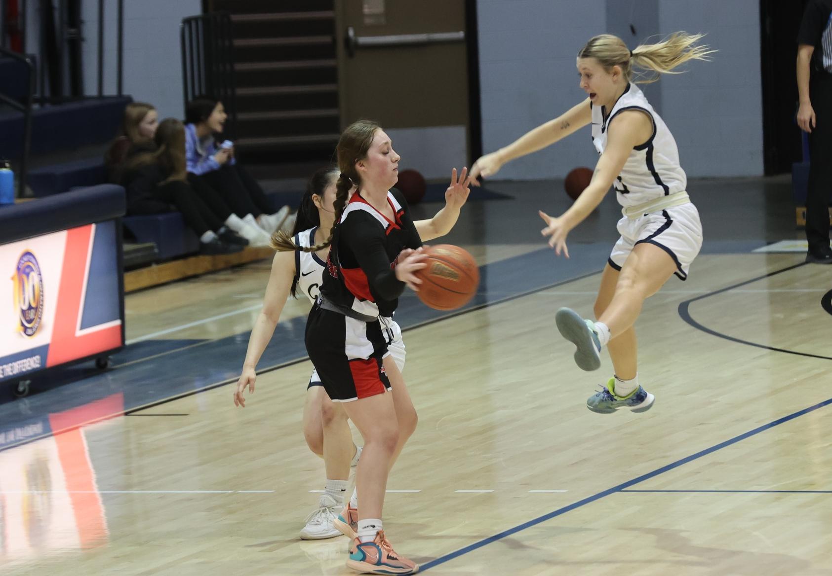 Bre Fowler shows her defensive effort as she soars high in the air for ball pressure.