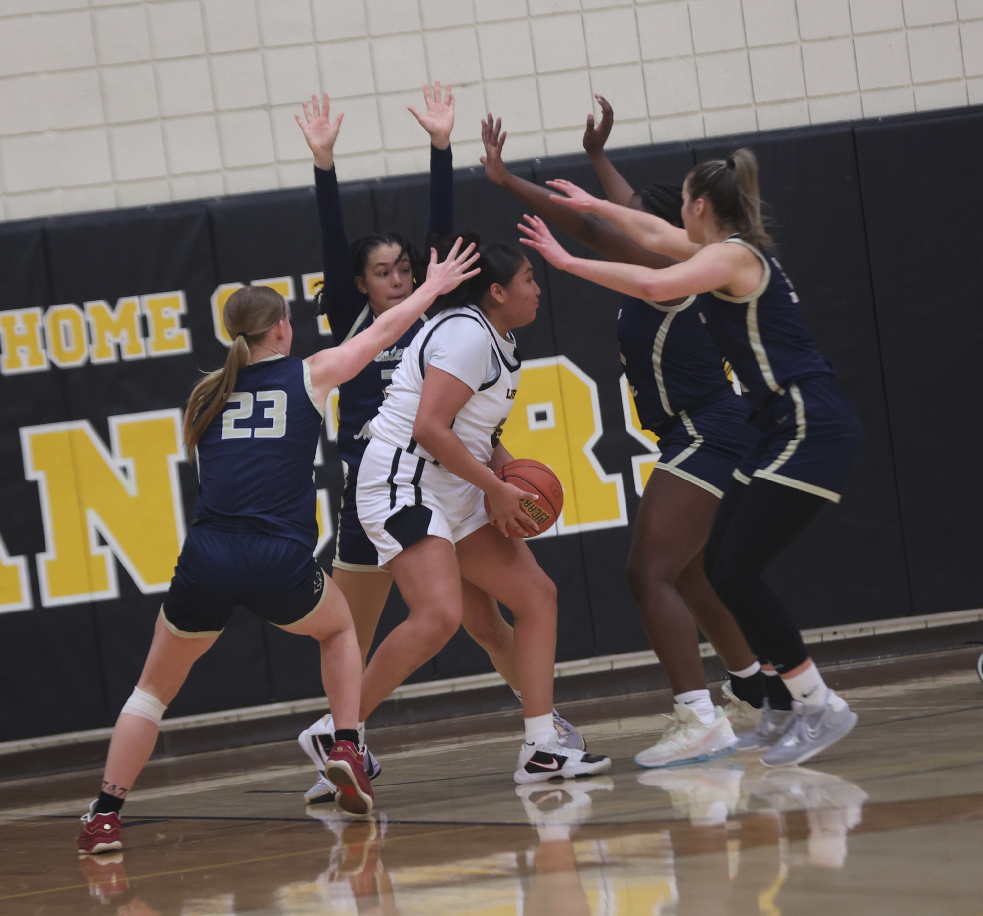 Four Cougars swarm around the EWC player on Monday.