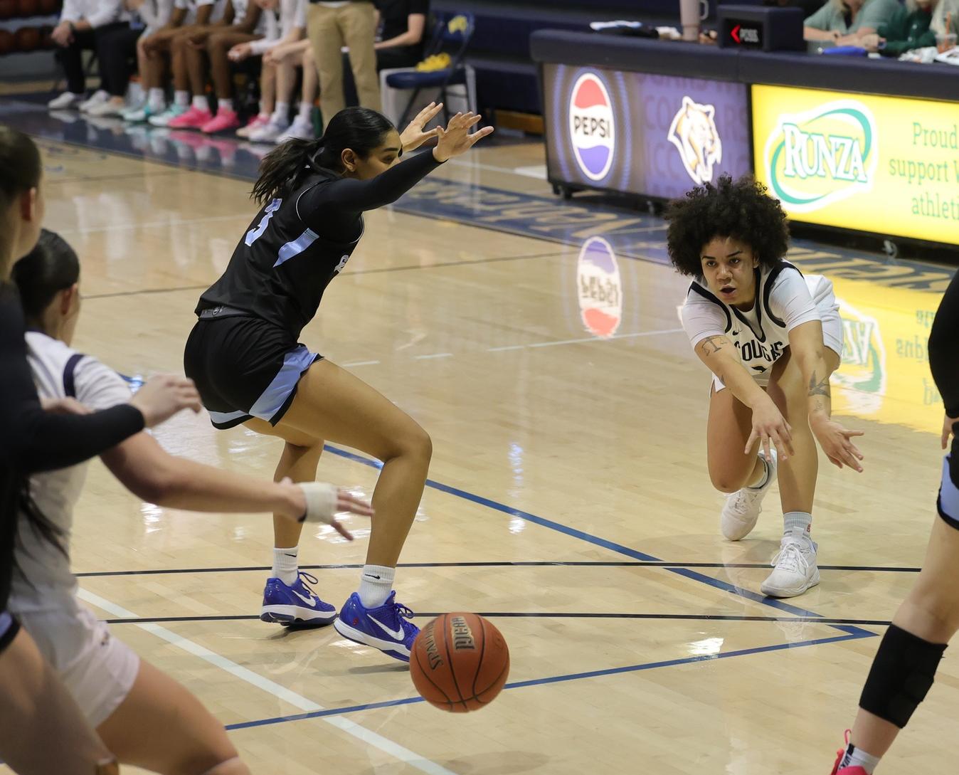 Ella Chesta-Carty delivers a pass down low to a Cougar player in their game with Gillette on Monday. (photo by Mark Rein)