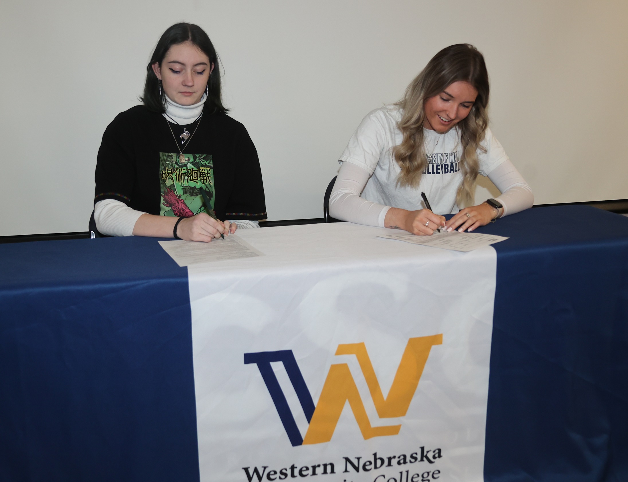 Maya and Charli signing.