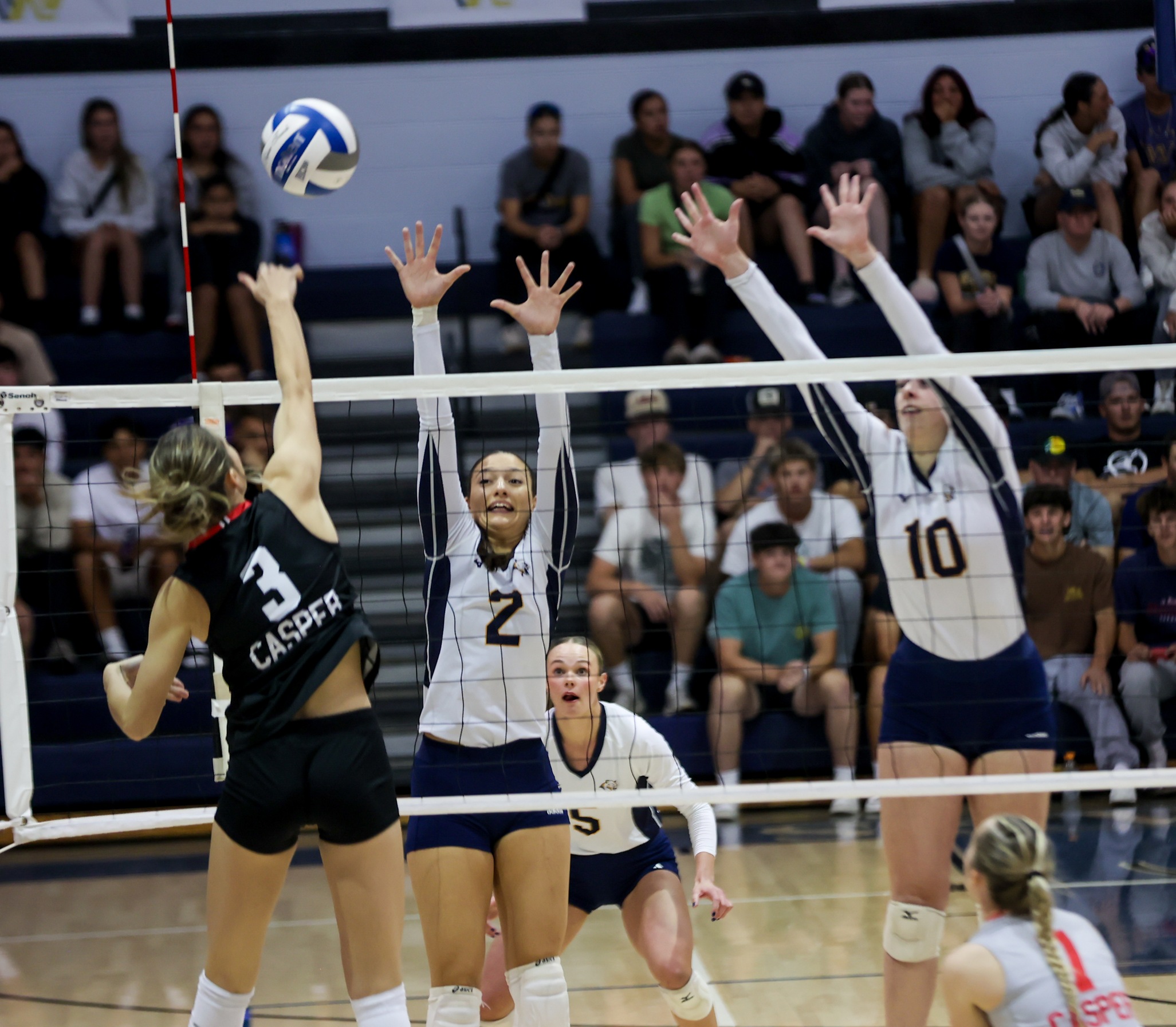 Nora Marginean and Finja Schul go up for a block against Casper when they played at Cougar Palace in September.